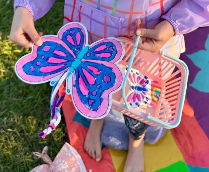 children doing craft activities in the park with Aunty Em