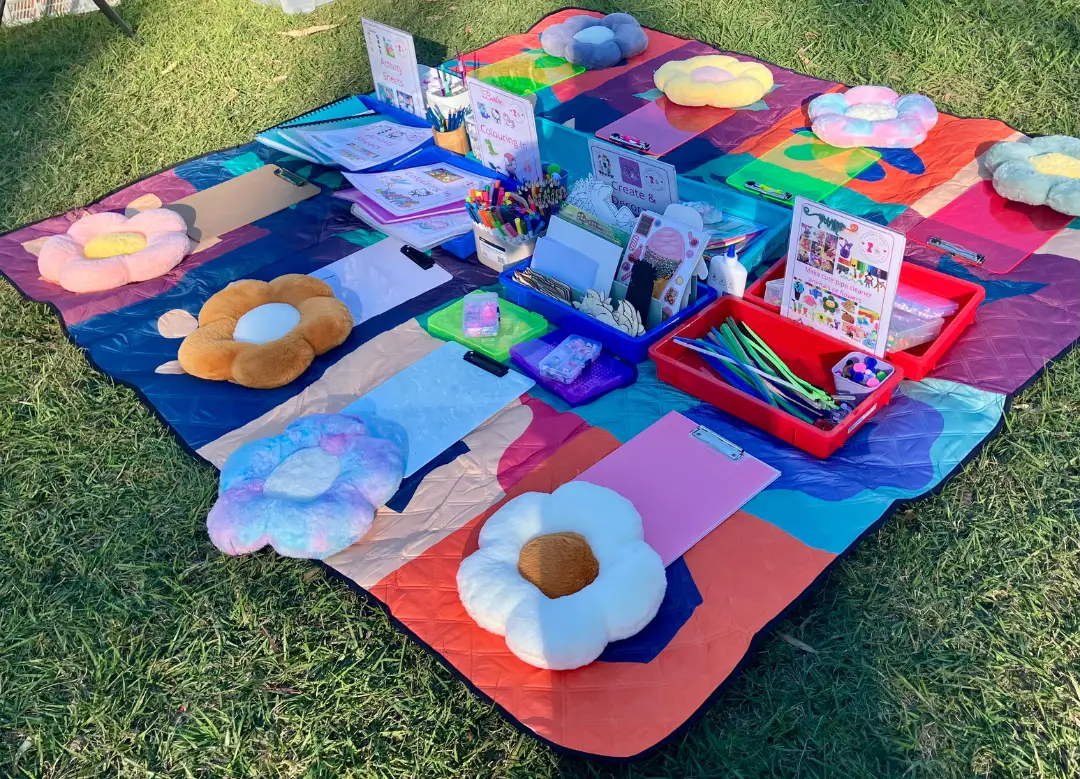 children doing craft activities in the park with Aunty Em