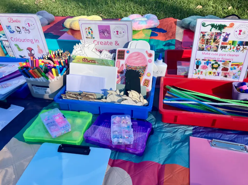 children doing craft activities in the park with Aunty Em