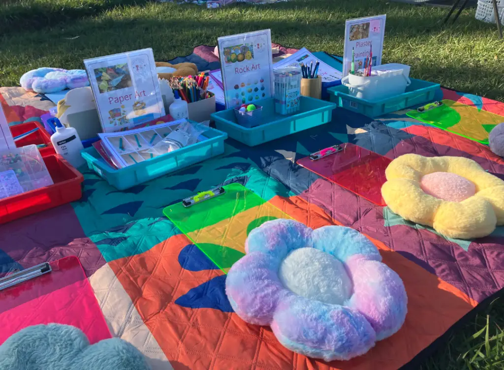 children doing craft activities in the park with Aunty Em