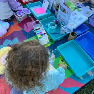 children doing craft activities in the park with Aunty Em