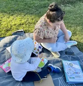 children doing craft activities in the park with Aunty Em