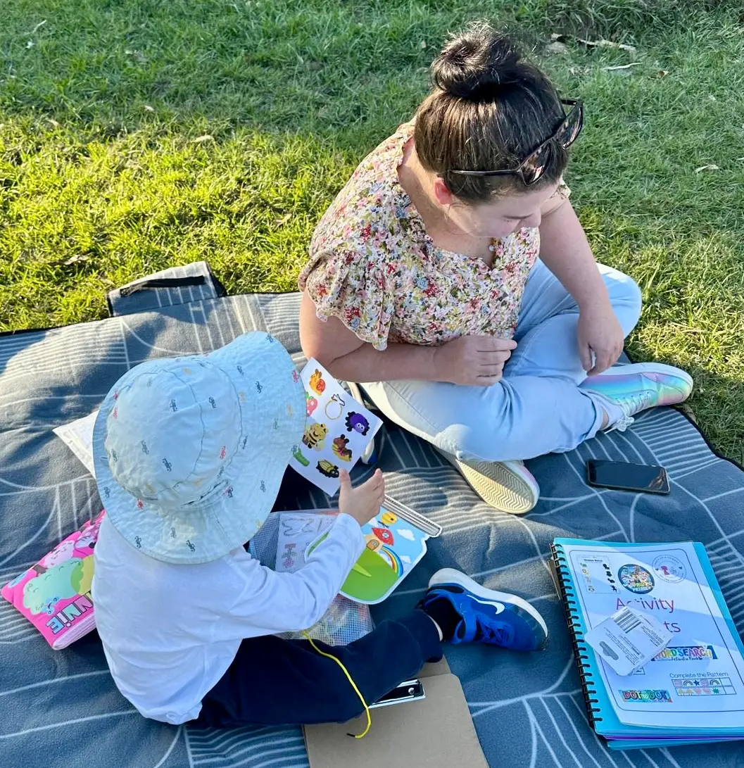 children doing craft activities in the park with Aunty Em